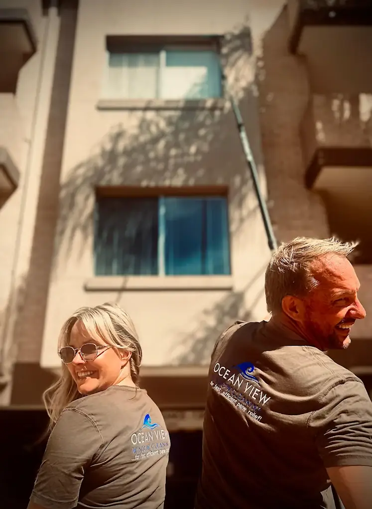 Window cleaning team in branded shirts